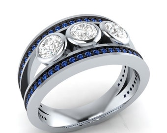 May include: A silver band ring with three round diamonds set in a row. The ring is accented with a row of blue sapphires on each side of the diamonds.