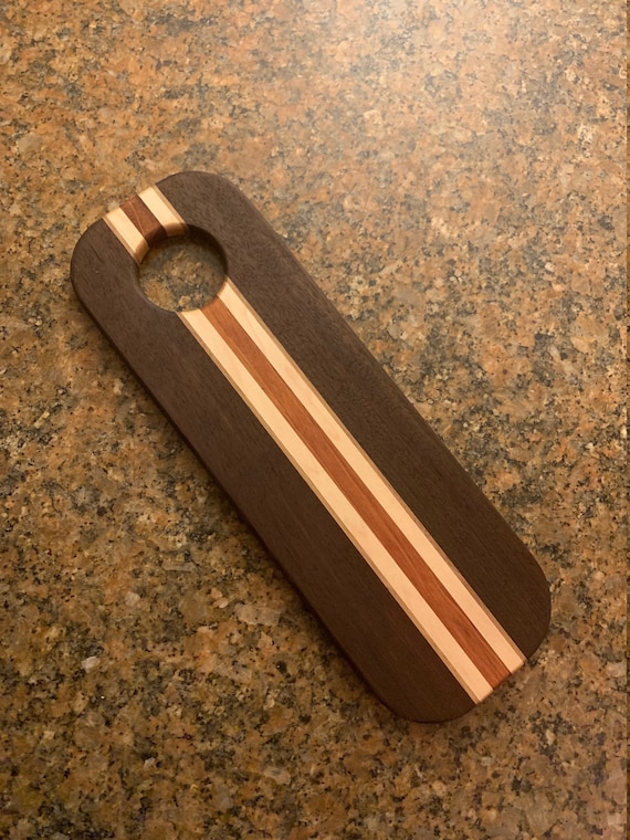 Multi-species wood board combining walnut, padauk, cherry, and maple creates a naturally striking color-block grain pattern — the padauk's vivid orange is a real showstopper.