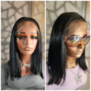 May include: Two images side-by-side showcasing a black wig on a mannequin head. The wig is a shoulder-length bob with a natural-looking hairline. The mannequin on the right wears large, tinted sunglasses. The mannequin on the left wears a gray top and a necklace.