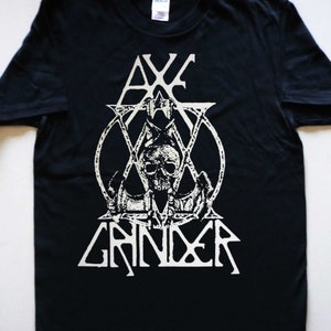May include: Black t-shirt with a white graphic of a skull with an axe and the text "Axe Grinder".