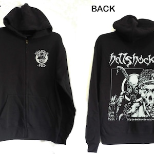 May include: Black zip-up hoodie with a white graphic on the front that says "KILLING JOCK -PDX-" and a white graphic on the back that says "HELLSHOCK" with a skull and the text "Only the dead know the end of war."
