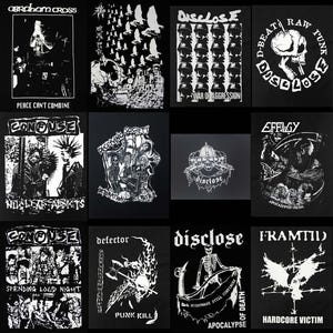 May include: A collection of black and white punk rock patches featuring various band logos and artwork. The patches include text such as "Abraham Cross", "Disclose", "Confuse", and "Defector", with imagery of skulls, figures, and graphic designs.