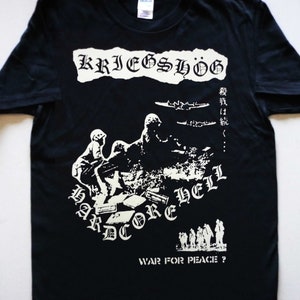 May include: Black t-shirt with a white graphic print of a band called "Kriegshög" with the text "Hardcore Hell" and "War for Peace?" The graphic features a silhouette of soldiers and airplanes.