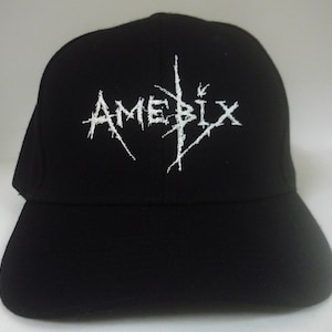 May include: Black baseball cap with a white embroidered logo that says "AMEBIX".