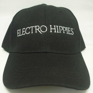 May include: Black baseball cap with white embroidered text that reads "Electro Hippies".