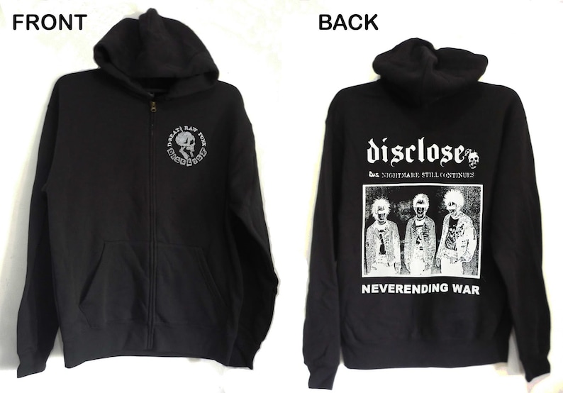 May include: Black zip-up hoodie with a white skull and crossbones graphic on the front and a white graphic on the back that says "Disclose" with the text "The Nightmare Still Continues" and "Neverending War" underneath.