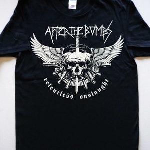May include: Black t-shirt with a white graphic of a skull with wings, a sword, and guns. The text "After the Bombs" and "Relentless Onslaught" are printed below the graphic.