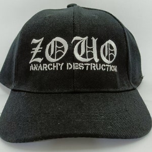 May include: Black baseball cap with white embroidered text that reads "ZOUO ANARCHY DESTRUCTION".