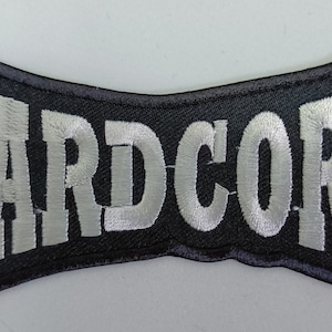 May include: Black embroidered patch with the word "HARDCORE" in white lettering.