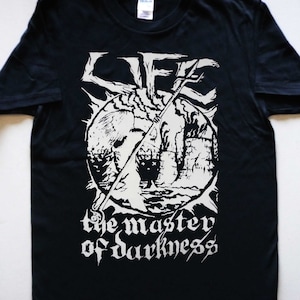 May include: Black t-shirt with a white graphic print of a skull with a sword through it. The text "the master of darkness" is printed below the skull.