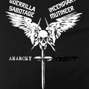 May include: Black graphic design featuring a skull with wings, a sword, and the word "ANARCHY." The text "GUERRILLA SABOTAGE" and "INCENDIARY MUTINEER" are also present in white. The design is bold and striking.