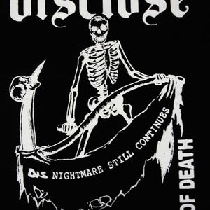 May include: Black graphic featuring a white skeleton figure holding a banner with the text "Das Nightmare Still Continues Of Death Apocalypse". The word "disclose" is at the top. The design is in a gothic style.