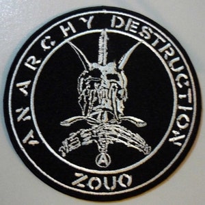 May include: Black and white embroidered patch with a skull and sword design. The text "ARCHY DESTRUCTION ZOUO" is written in a circle around the design.