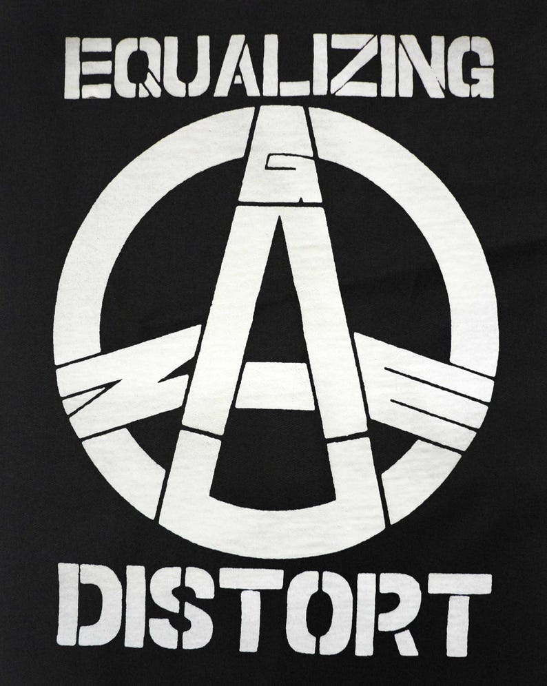 May include: Black t-shirt with a white graphic. The graphic features a large white circle with a stylized letter "A" inside, and the words "EQUALIZING" and "DISTORT" above and below the circle in a stencil font.