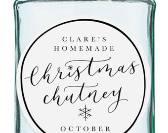 May include: A clear glass jar with a silver lid and a white round label. The label has black text that reads "Clare's Homemade Christmas Chutney" with a snowflake symbol and the date "October 2020".