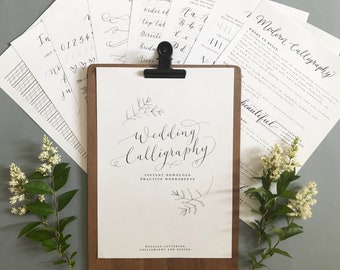 May include: A white sheet of paper with the text "Wedding Calligraphy" in black calligraphy font. The paper is on a clipboard with a brown wooden frame. There are two small drawings of branches with leaves on the paper. The text "Instant Download Practice Worksheets" is below the title. The text "Wallace Lettering Calligraphy and Design" is at the bottom of the page.