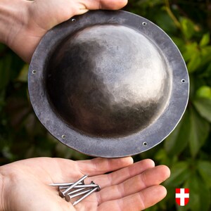 6 nails for mounting the umbon are included with the umbon. When you buy this umbon, you will have all the necessary details to attach the umbon to your shield.