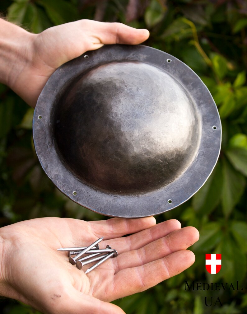 6 nails for mounting the umbon are included with the umbon. When you buy this umbon, you will have all the necessary details to attach the umbon to your shield.