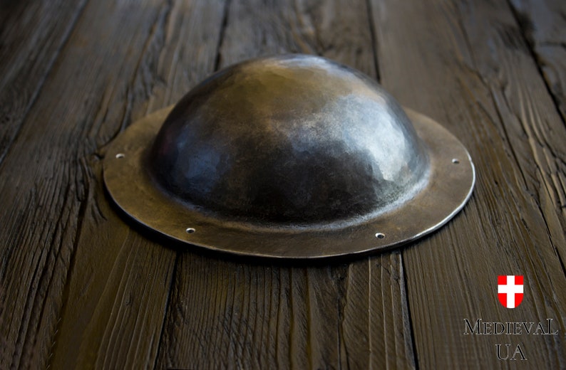 the shape of the umbon resembles the shape of a hat. the convex part has a hemispherical shape and flat sides, which lean against a horizontal surface, if you put umbon on a table or other surface.