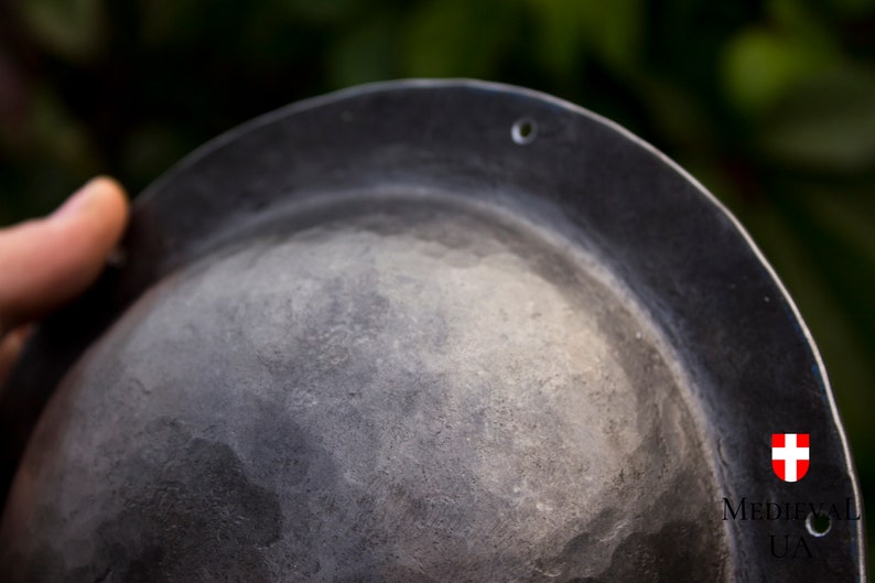 on the flat sides of the umbon there are 6 holes of 3.2 mm for nailing the umbon to the shield with nails.