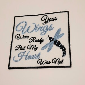 May include: White embroidered patch with a blue dragonfly and the text "Your Wings Were Ready But My Heart Was Not".