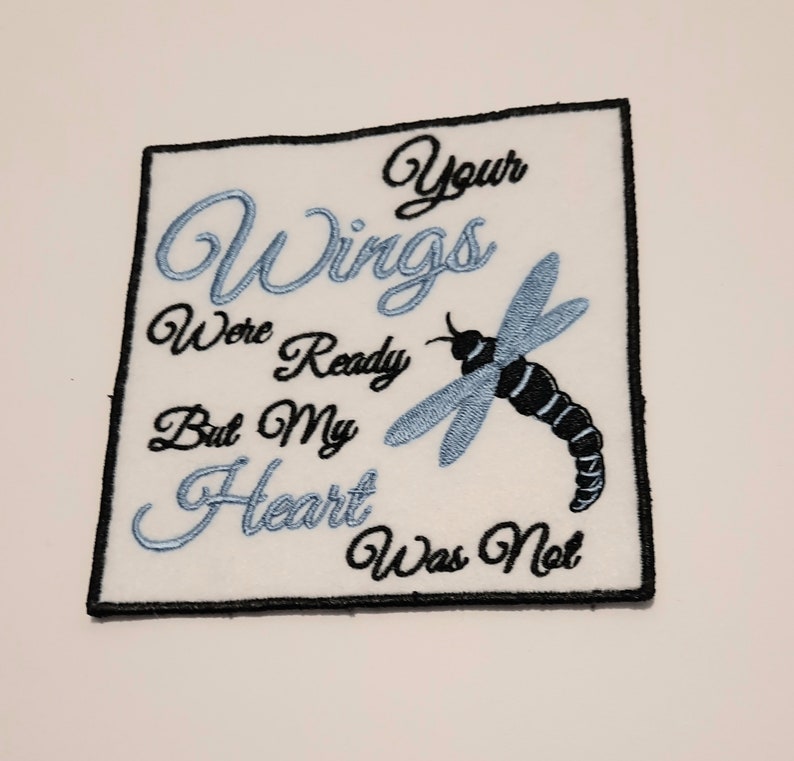 May include: White embroidered patch with a blue dragonfly and the text "Your Wings Were Ready But My Heart Was Not".