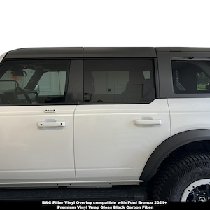 May include: White Ford Bronco with black vinyl overlay compatible with 2021+ models. B&C Pillar Vinyl Overlay compatible with Ford Bronco 2021+ Premium Vinyl Wrap Gloss Black Carbon Fiber