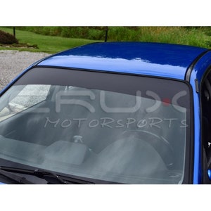 May include: A blue car with a black windshield banner that reads "CRUX MOTORSPORTS".