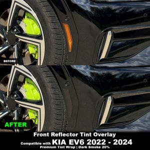 May include: A front reflector tint overlay for a Kia EV6 2022-2024. The image shows a before and after comparison of a black car fender with a bright orange side reflector, which is covered by a dark smoke 20% premium tint wrap overlay.