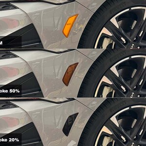 May include: Three images of a car's rear taillight with different levels of tinting. The top image shows the taillight with no tint, labeled "OEM". The middle image shows the taillight with light smoke tint, labeled "Light Smoke 50%". The bottom image shows the taillight with dark smoke tint, labeled "Dark Smoke 20%".