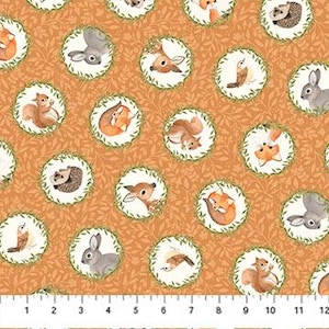 May include: A repeating pattern of woodland creatures, including foxes, deer, squirrels, rabbits, and hedgehogs, inside circular frames with green leaf borders. The background is a warm, orange-brown color. A ruler at the bottom shows measurements in inches.