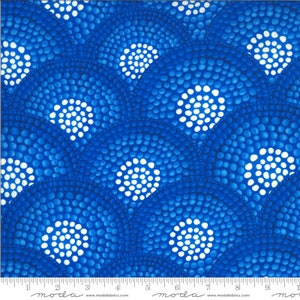 May include: Blue and white fabric with a repeating pattern of white dots arranged in circles. The fabric has a textured look and feel.