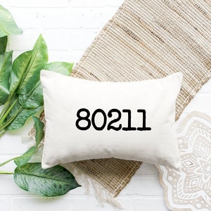May include: White cushion with the number 80211 printed in black.