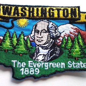 May include: Embroidered patch depicting a map of Washington State with the word "WASHINGTON" in yellow. The design includes an image of George Washington, evergreen trees, mountains, and the text "The Evergreen State 1889".