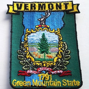 May include: An embroidered patch in green, featuring the state seal of Vermont. The seal depicts a green pine tree, a blue sky, and a yellow banner with the text "VERMONT 1791". The patch also includes the text "Green Mountain State" in yellow.