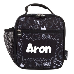 May include: Black lunch bag with a white and gray print of various gaming and sports related icons. The bag has a zippered front pocket and a mesh side pocket. The name "Aron" is printed in white on the front of the bag.