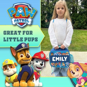 May include: A blue Paw Patrol lunch bag featuring the name EMILY in white letters, surrounded by cartoon character graphics. The bag has a top handle and a side mesh pocket, displayed alongside Paw Patrol branding and the text GREAT FOR LITTLE PUPS.