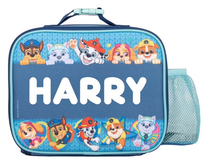 May include: A rectangular blue lunch bag featuring the name HARRY in large white letters. The bag is decorated with Paw Patrol character graphics, including Chase, Marshall, Skye, Rubble, and Everest, along with a light blue mesh side pocket.