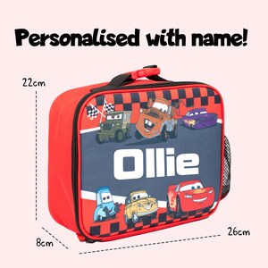 Pode incluir: Saco de almo&ccedil;o vermelho e preto com uma al&ccedil;a, com carros de desenho animado e o nome "Ollie". A bolsa tem 26 cm de comprimento, 22 cm de altura e 8 cm de largura. O texto "Personalizado com nome!" est&aacute; no topo.