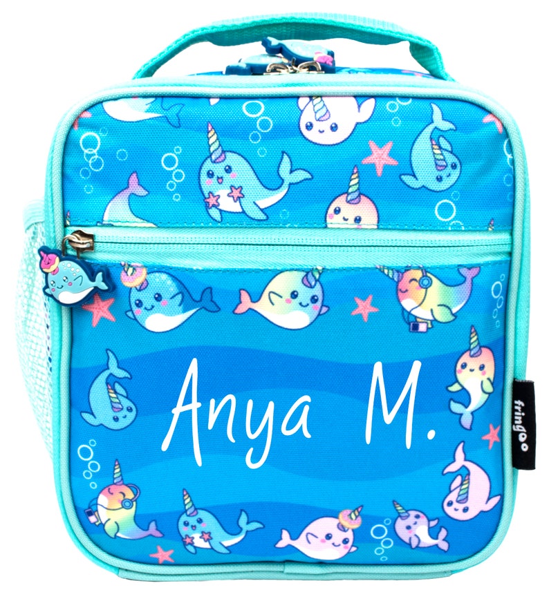 May include: A turquoise blue lunch bag with a zipper closure and a mesh side pocket. The bag features a whimsical design of narwhals with rainbow horns and a blue ocean background. The bag is personalized with the name "Anya M."