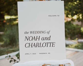 May include: White sign with black text on an easel. The sign reads "Welcome to the wedding of Noah and Charlotte, April 7, 2023, Phoenix, AZ".