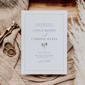 May include: A wedding invitation with gold trim, featuring the names Layla Rosen and Camden Hayes, and the date 07.18.25. The invitation is on a white background with a minimalist tree design. The invitation is on a wooden tray with a beige cloth and decorative elements.