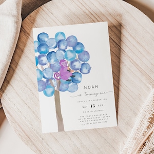 May include: A white invitation card with a watercolour illustration of a blue tree with a purple monkey sitting on a branch. The text on the card reads "Noah is turning one. Join us in celebration. Sat 15 Feb. 2-4 in the afternoon. The Costa Residence. 1115 Alpine Ridge, Aspen. RSVP by February 1st. To answer at 123.456.7890."