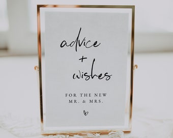 Op de afbeelding: Een gouden lijst met een witte achtergrond en zwarte tekst die "advice + wishes for the new mr. & mrs." met een klein hartje onderaan staat.