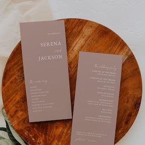 May include: Two light brown wedding ceremony cards with white text. The left card has the text "the wedding of Serena and Jackson" and the ceremony order. The right card has the text "the wedding party" and lists the names of the wedding party members.