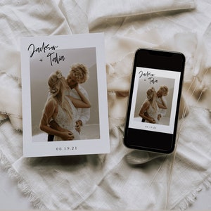 May include: A white card with a photo of a couple kissing. The card has the text "Jackson + Talia" and "06.19.21" printed on it. A smartphone with a similar photo and text is lying on a white fabric surface.