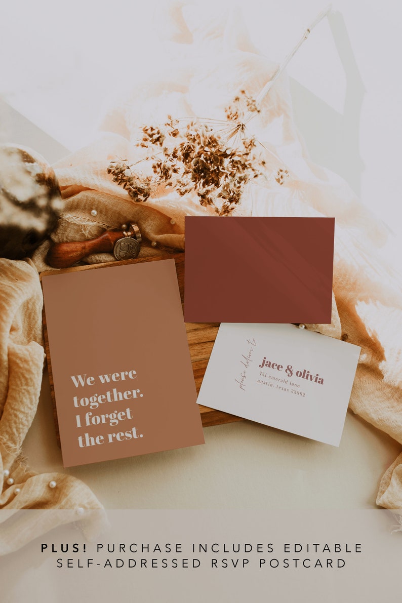 May include: A brown card with the text "We were together. I forget the rest." and a white card with the text "please reply to jace & olivia 761 emerald lane austin, texas 33892". The cards are on a wooden surface with a brown fabric and dried flowers.