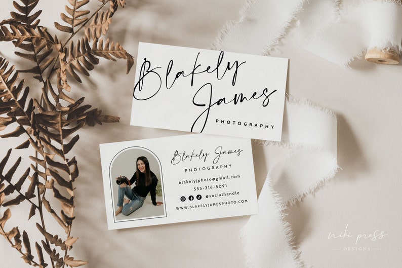 May include: White business card with black text. The text reads "Blakely James Photography" and includes contact information for the photographer. A photo of the photographer is in the corner of the card.