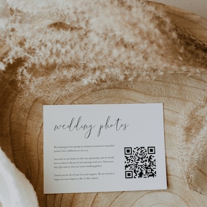 May include: A white card with the text "wedding photos" in black cursive script. The card includes a QR code and the text "We exchanged vows during an intimate ceremony in beautiful Joshua Tree, California on 06.11. You were in our hearts on this very special day, and we would love to share in the joy of our marriage with you. Please scan this QR code to view our entire wedding gallery. Thank you for all of your love and support. We are excited to begin our next chapter as Mr. & Mrs. James!"