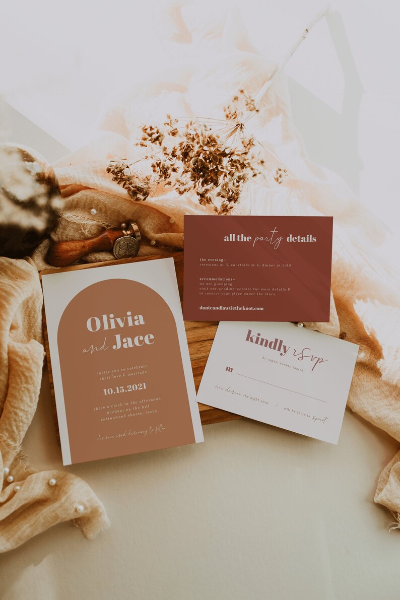 May include: A wedding invitation suite with a brown and white color scheme. The invitation features a rounded rectangle with the text "Olivia and Jace" in a bold, white font. The RSVP card features the text "kindly RSVP" in a cursive font.